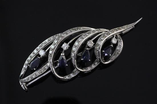 An 18ct white gold, sapphire and diamond brooch, 2.25in.